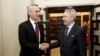 NATO Secretary-General Jens Stoltenberg (left) and Finnish Foreign Minister Pekka Haavisto shake hands at the Finnish parliament in Helsinki on February 28.