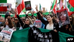 Women protest during an opposition rally in solidarity with the Iranian people on the 44th anniversary of the Islamic Revolution in Paris on February 11.