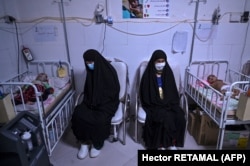 Afghan women sitting next to their babies receiving treatment for malnutrition at a Doctors Without Borders (MSF) nutrition center in Herat. (file photo)