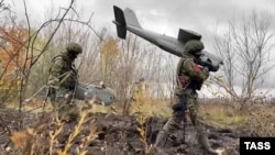 A Russian soldier carries an Orlan aerial drone in eastern Ukraine in November.