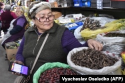 A Kyrgyz vendor sells the indigenous aconite root at a bazaar in Bishkek late last week.