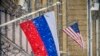 A Russian flag flies next to the U.S. Embassy building in Moscow.