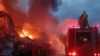 Pakistani firefighters battle a blaze that erupted in a warehouse at a hydropower dam construction site in Khyber Pakhtunkhwa Province on April 4.