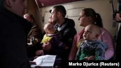 People sit inside an evacuation train, after leaving their village near the Bakhmut front line on February 13.