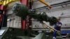 A man works on an assembly line for German weapons manufacturer Rheinmetall. 