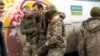 An injured Ukrainian prisoners of war is helped by comrades following a prisoner swap with Russia in April last year. 