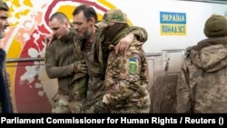 An injured Ukrainian prisoners of war is helped by comrades following a prisoner swap with Russia in April last year. 