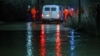 Rescuers evacuate local people from the flood-hit area in Nikel in the Orenburg region on April 6.