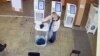 A woman pours a liquid into a ballot box during the Russian presidential election in Moscow on March 15.