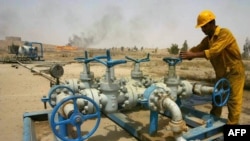 A worker checks the valves at the Kirkuk oil field.