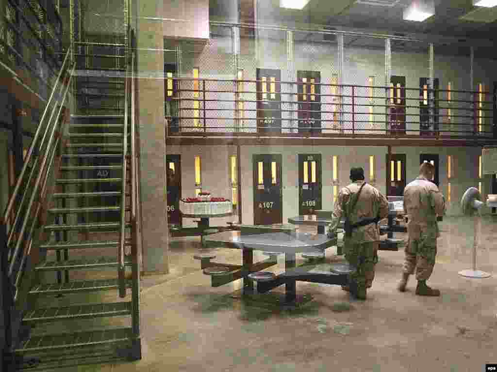 U.S. soldiers stand guard in a cell block in Camp Delta at Guantanamo Bay.