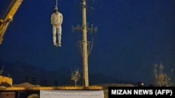 A photo obtained from the Iranian Mizan news agency on December 12 shows the public execution of Majidreza Rahnavard in Iran's Mashhad city, the second capital punishment linked to nearly three months of protests.