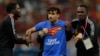 Mario Ferri is detained by officials after encroaching onto the field of play during Portugal's World Cup game against Uruguay on November 29 