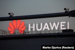 Surveillance cameras in front of a Huawei logo in central Belgrade in 2020.