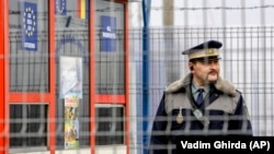 A Romanian border guard stands on duty at a railway border-crossing point at the EU's external border with Moldova. (file photo)