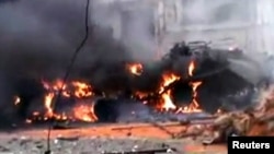 A tank burns, allegedly after being attacked by insurgents from the Free Syrian Army, in the city of Homs on January 12.