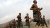 Afghan recruits run in formation at the Afghan National Army Officers' Academy in the Qargha district of Kabul on October 23.