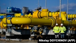 Workers walk onsite at a gas metering station of a pipeline link between Bulgaria and Greece near the village of Malko Kadievo, Bulgaria. 