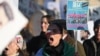 Protesters hold placards at a march in central London on January 21 against the Islamic Revolutionary Guards Corps (IRGC).