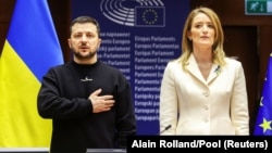 Ukrainian President Volodymyr Zelenskiy poses next to European Parliament President Roberta Metsola after arriving for a summit in Brussels on February 9.