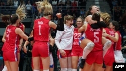 Serbian women volleyball players celebrate their victory over the United States in the semifinals of the World Championship. After they won the tournament this month, the team received a donation worth hundreds of thousands of euros from a Chinese mining company. 