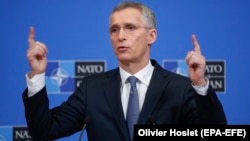 NATO Secretary-General Jens Stoltenberg talks to reporters ahead of a defense ministers meeting at NATO headquarters in Brussels on February 12.