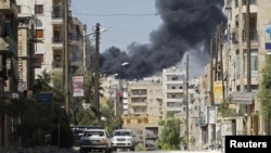 Smoke rises from the El-Edaa district of Aleppo after missiles were launched by a Syrian Air Force fighter jet on September 5.