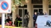 French police, soldiers, and fire fighters work at the site where a teacher was killed and several people injured in a knife attack at a high school in Arras, in northern France