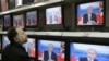 A Moscow man watches the televised question-and-answer program with President Putin on October 18