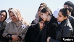 Mourners react during the funeral of Kurdish medical student Shinda Kisho, who was killed in Latakia, March 9