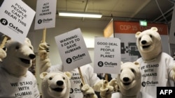 Activists in polar bear costumes as they prepare for a "Save Humans Too" demonstration in Copenhagen.