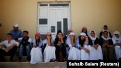 Yazidis attend a commemoration marking the third anniversary of the Yazidi genocide in the Sinjar region of Iraq on August 3. 