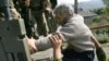 Russian troops in South Ossetia usher ethnic Georgian Tariel Basishvili into the back of a truck bound for Tbilisi on September 5.