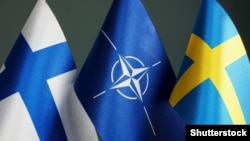 The flags of Finland, NATO, and Sweden. Twenty-eight out of 30 NATO allies have now ratified the two countries' protocols of accession to the military alliance. Hungary and Turkey, however, abstained. 