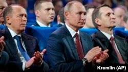 FSB Director Aleksandr Bortnikov (left), Russian President Vladimir Putin (center), and Foreign Intelligence Service Director Sergei Naryshkin (right) attend a meeting with intelligence officers in Moscow in December 2019.