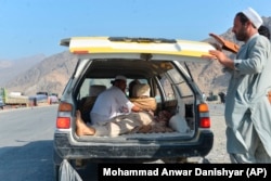 A victim of the blast is carried away in a car in Nangarhar Province on September 11.