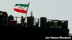 A crew member raises the Iranian flag on Iranian oil tanker Adrian Darya 1 in mid-August while in Gibraltar.