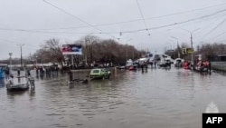 Russian rescuers evacuate residents during a flood in the town of Orsk on April 7.