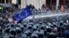 Riot police disperse opposition supporters during a protest rally in front of the parliament building in Tbilisi on November 18. 