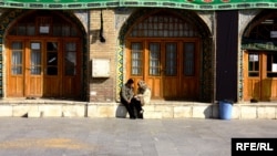 Two young people chat outside the Imamzade Ismayil Mausoleum in Qazvin, Iran. (file photo)