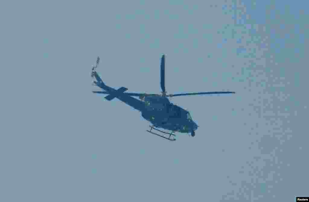 A Pakistani Army helicopter flies over the school.