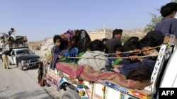 Displaced families flee from military operations against Taliban militants in South Waziristan.