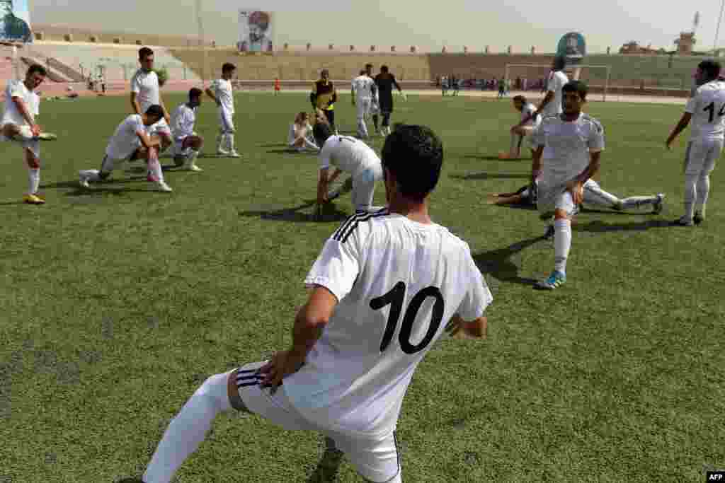 Afghan pro football players training at a Kabul stadium on September 2.