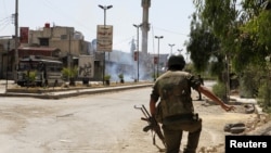 A soldier runs after a bomb explodes on a street in the town of Douma near Damascus on May 20.