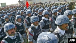 Iraqi security officers parade in the city of Najaf.