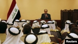 Iraqi Prime Minister Nuri al-Maliki speaks during a meeting with tribal leaders in Mosul in late May.