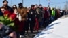 Mourners line up to visit the grave of Russian opposition leader Aleksei Navalny at Borisovskoye cemetery in Moscow on March 3. 