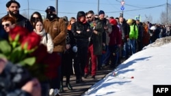 Mourners line up to visit the grave of Russian opposition leader Aleksei Navalny at Borisovskoye cemetery in Moscow on March 3. 