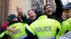 Police try to prevent demonstrators from blocking entrances to parliament and prevent lawmakers from entering the building in Tbilisi on December 12.