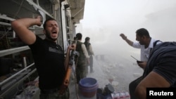 Rebel fighters run for cover after government forces fired a mortar in the El-Amreeyeh neighborhood of the northwestern Syrian city of Aleppo.